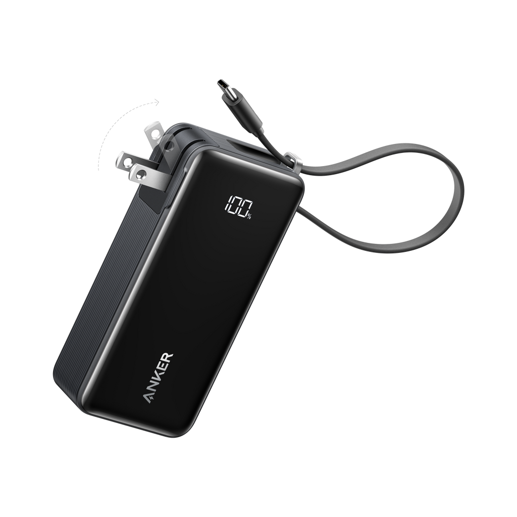 Anker power bank with foldable plug and display for charging.